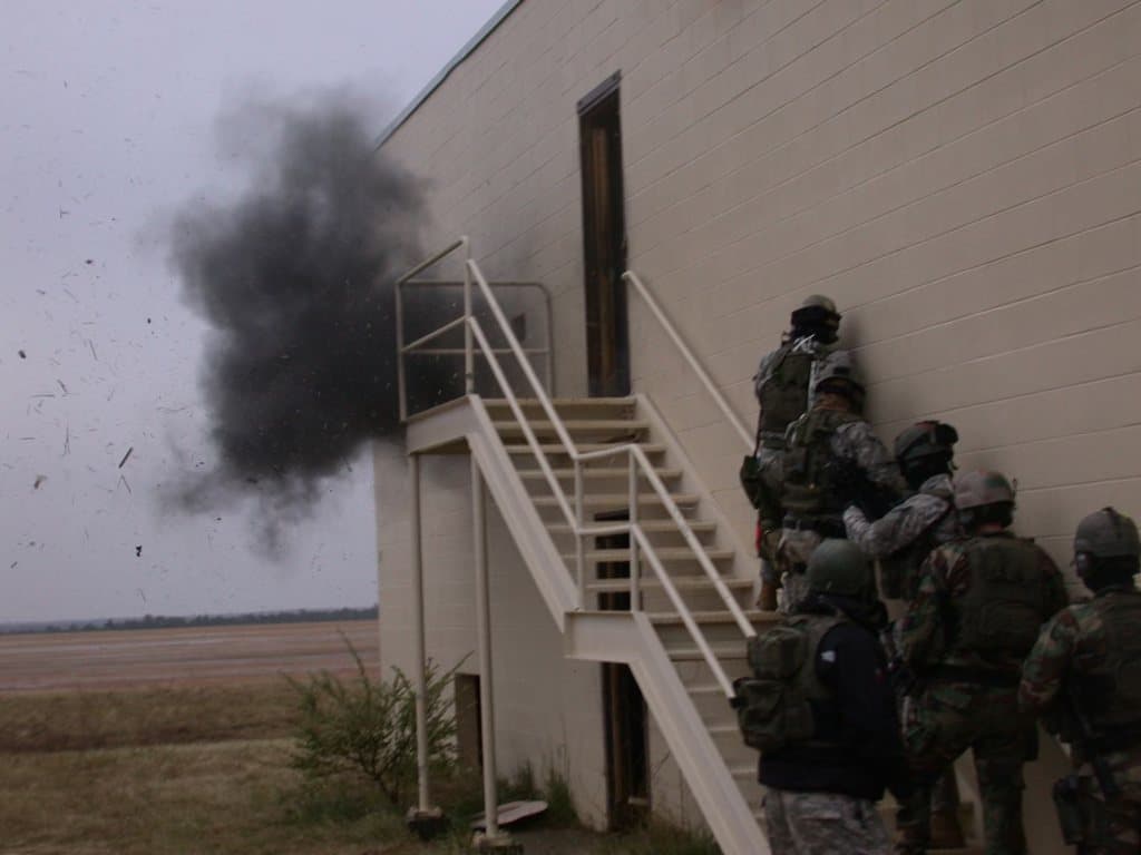 A team stacked outside a building during training