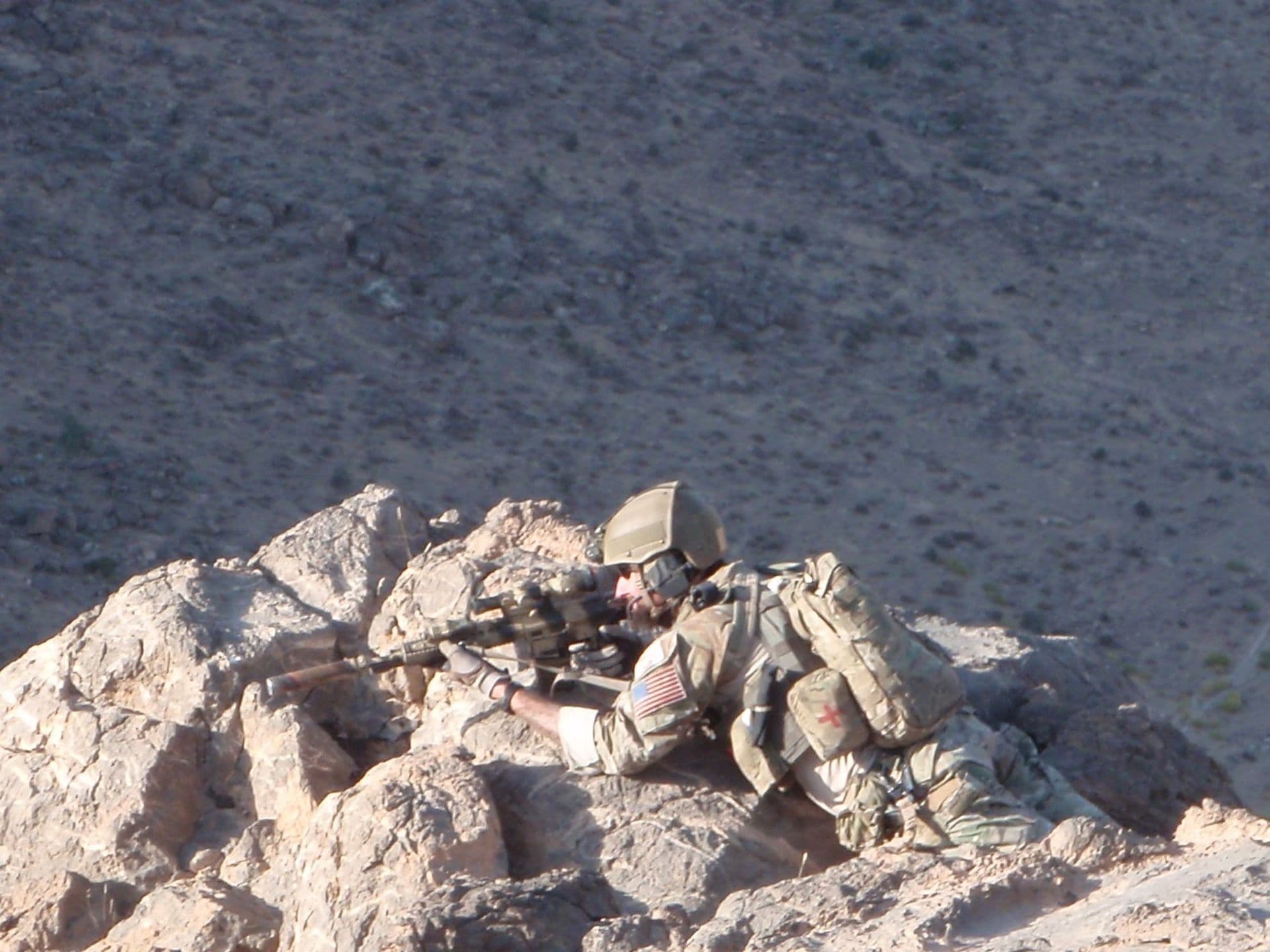 An operator holding position in rocky terrain