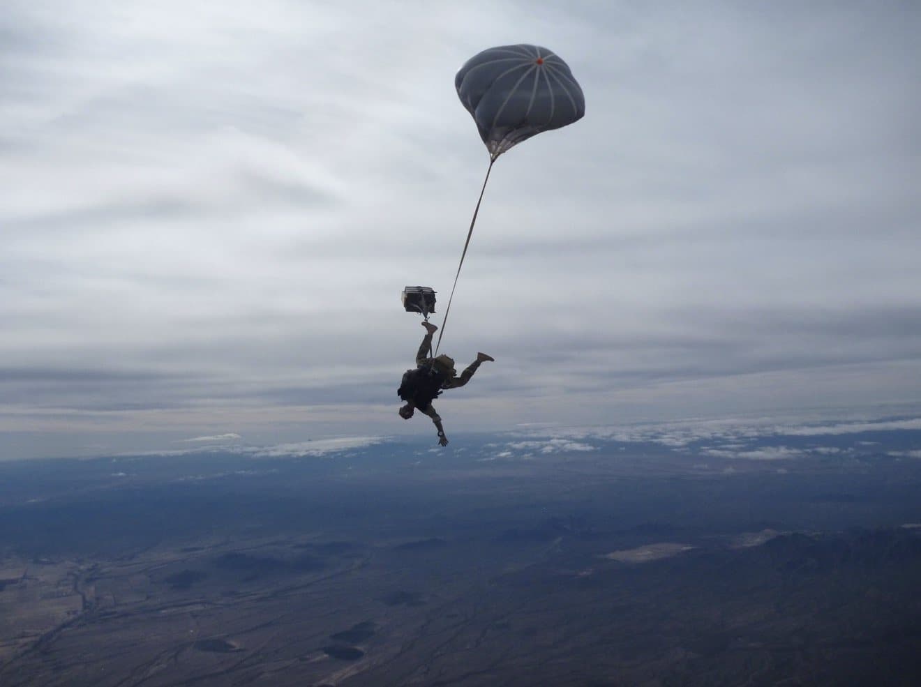 A jumper under canopy over open country