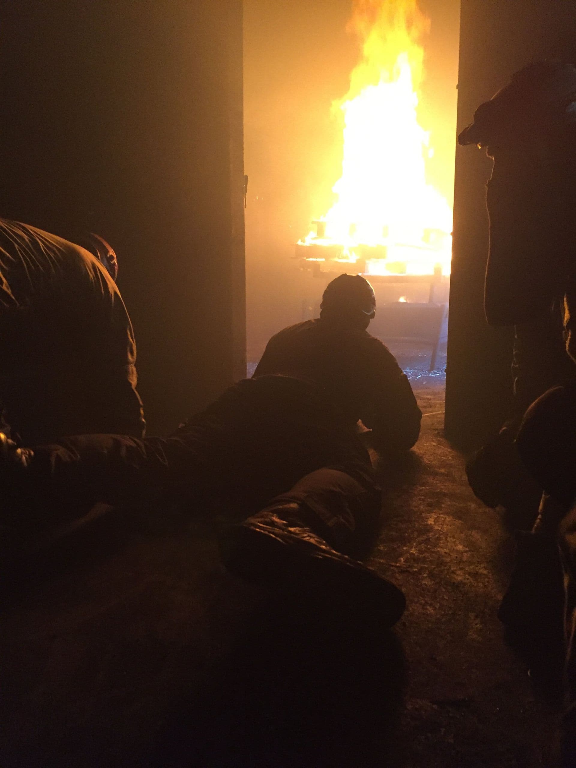 Firefighters holding the line during a live-burn training evolution